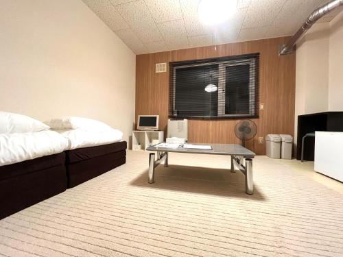 a room with a bed and a coffee table at Maison Loire - Vacation STAY 18226 in Hakodate