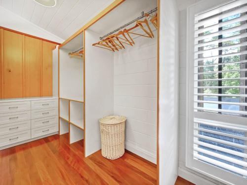 a walk in closet with white walls and a window at Luxurious Mountain Retreat near Maleny in Booroobin
