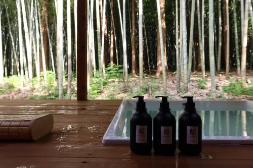 three bottles of wine sitting on a tray on a table at and FOREST Katsuura Take no Hanare - Vacation STAY 91561v in Katsuura