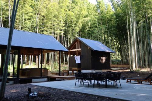 a pavilion with tables and chairs in a forest at and FOREST Katsuura Take no Hanare - Vacation STAY 91561v in Katsuura