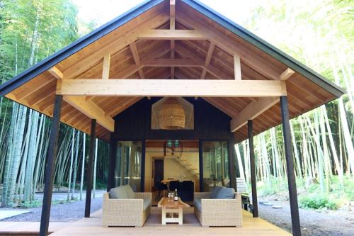 a pavilion with chairs and a table in the woods at and FOREST Katsuura Take no Hanare - Vacation STAY 91561v in Katsuura