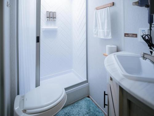 a bathroom with a shower and a toilet and a sink at Gramercy Village Lake Yamanaka Glamping & Sauna - Vacation STAY 92835v in Yamanakako