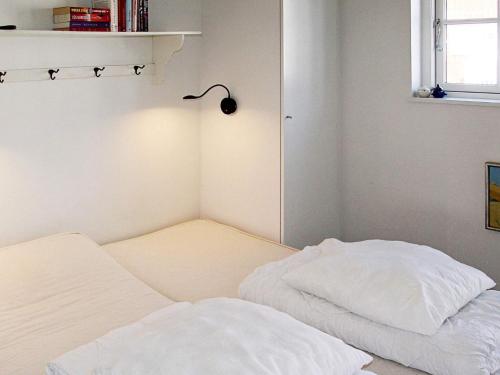 a small room with two beds and a lamp at 6 person holiday home in Bagenkop in Bagenkop