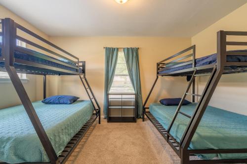 two bunk beds in a room with a window at SA Randolph New Braunfels Vacation home with King Bd Sleeps 10 in San Antonio