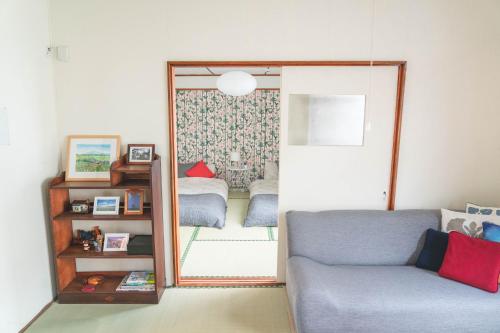 a living room with a mirror and a couch at NU1 Guesthouse NUI okhotsk女満別 in Abashiri