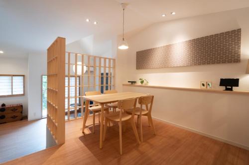 a kitchen and dining room with a wooden table and chairs at Hana no kage - Vacation STAY 96334v in Sengokuhara
