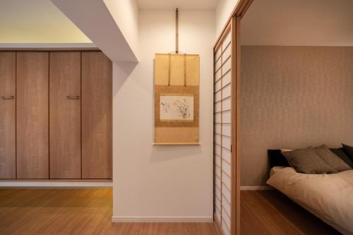 a bedroom with a bed next to a cabinet at Hana no kage - Vacation STAY 96334v in Sengokuhara