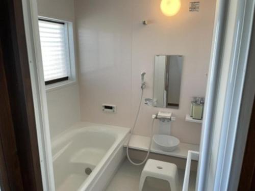 a white bathroom with a tub and a toilet at DOG LEG - Vacation STAY 98415v in Funakata
