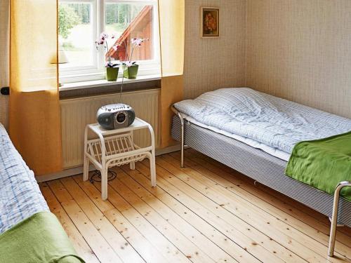 a small room with a bed and a window at 6 person holiday home in GAMLEBY-By Traum in Gamleby