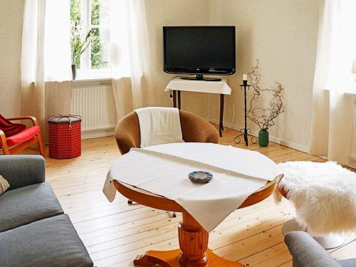 a living room with a table and a tv at 6 person holiday home in GAMLEBY-By Traum in Gamleby