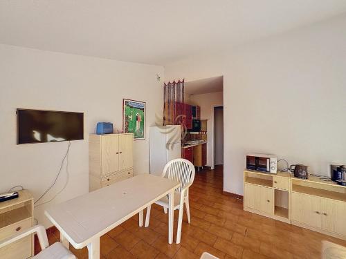 a living room with a table and a refrigerator at Panoramic Levant view–4 ppl–Sea–Pool–Tennis in Saint-Raphaël