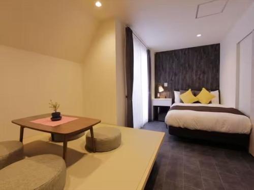 a hotel room with a bed and a table at Chaan Ueno Hotel - Vacation STAY 01159v in Tokyo