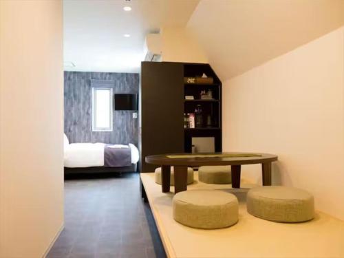 a living room with a table and a bed at Chaan Ueno Hotel - Vacation STAY 01162v in Tokyo