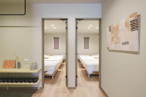 a room with two beds and two mirrors at Green Peak - Vacation STAY 05851v in Minami Aso