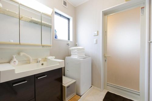 a white bathroom with a sink and a mirror at HANA - Vacation STAY 18403 in Nagoya