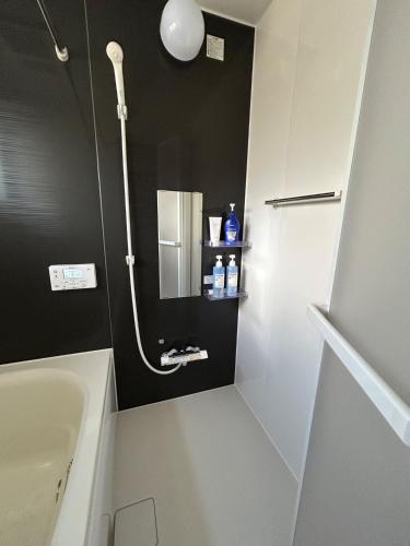 a bathroom with a shower and a tub and a sink at OUCHI Oaramachi - Vacation STAY 18642 in Goto
