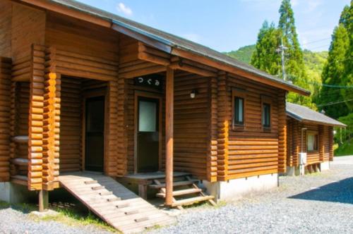a log cabin with a porch and a door at Tom sawyer adventuer village - Vacation STAY 55798v in Mimasaka