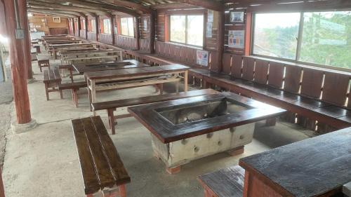 an empty train room with benches and tables at Uenodai Midorinomura - Vacation STAY 33460v in Yasugi
