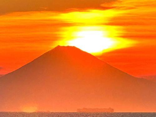 a sunset over a pyramid with a ship in front of it at kupono - Vacation STAY 00641v in Minamiboso