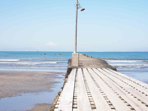 a pier on the beach with people in the water at kupono - Vacation STAY 00641v in Minamiboso