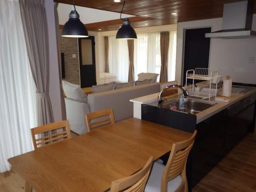 a kitchen and living room with a table and a sink at VILLAX Toyama - Vacation STAY 15561v in Tonami