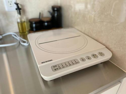 a microwave sitting on top of a counter at THE LAND HOTEL - Vacation STAY 15680v in Arao