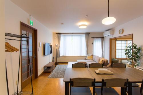 a living room with a couch and a table in a room at ObihiroINN - Vacation STAY 18480 in Obihiro