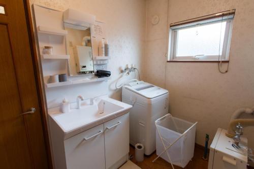 a bathroom with a sink and a washing machine at ObihiroINN - Vacation STAY 18480 in Obihiro