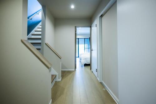 a hallway with stairs and a bed in a room at Seaside Villa N - Vacation STAY 21991v in Mitsugoe