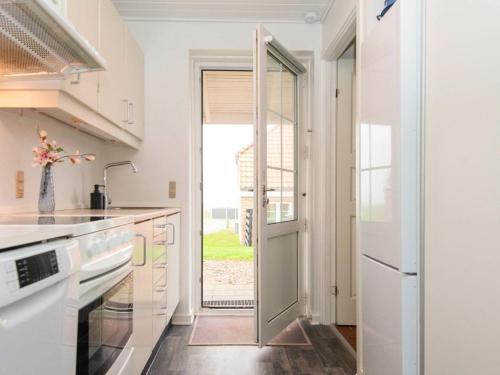 a kitchen with a door leading to a yard at Seaside Fun Retreat-By Traum in Lemvig