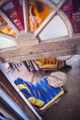 an overhead view of a table and chairs with stained glass at Zanzibar Coffee House in Zanzibar City
