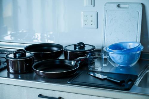 a group of pots and pans on a stove top at Seaside Villa N - Vacation STAY 21989v in Mitsugoe