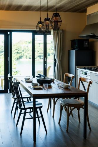 a kitchen with a wooden table with chairs and a dining room at Seaside Villa N - Vacation STAY 21989v in Mitsugoe
