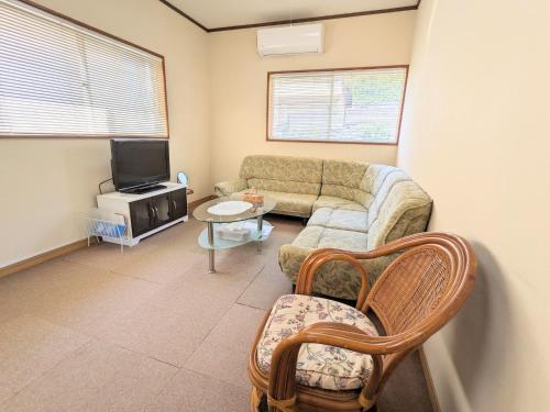 a living room with a couch and a tv at Minpaku ROADHOUSE - Vacation STAY 20160v in Nagasaki