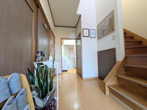 a living room with a staircase and a couch at Minpaku ROADHOUSE - Vacation STAY 20160v in Nagasaki