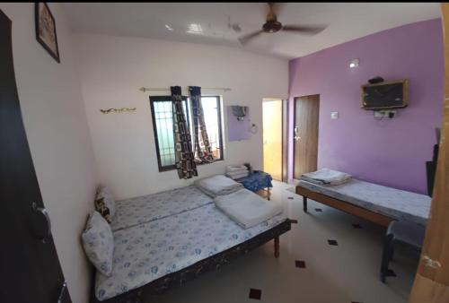 a room with a bed and a table and a mirror at Devbhoomi Residency-Dwarka in Dwarka