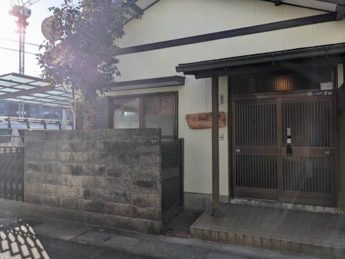 a building with a door and a fence in front of it at Oyado Ichi - Vacation STAY 33546v in Ise