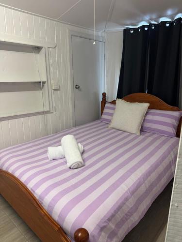 a large bed with two white pillows on it at Panacea Rising in Yeppoon