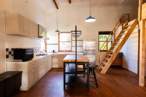 a kitchen with a table and a staircase in a room at Cardiff-Kujukuri- - Vacation STAY 48763v in Kujukuri