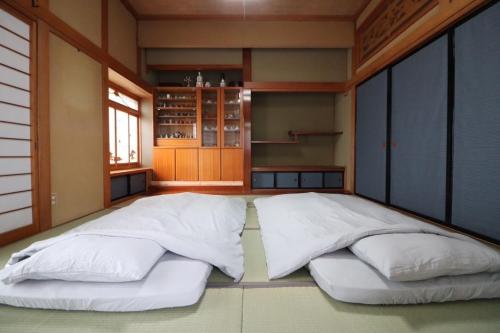 a large bed in a room with two pillows at Dekopin House - Vacation STAY 18550 in Hanamaki
