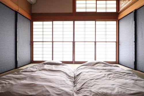 a large bed in a room with a large window at Dekopin House - Vacation STAY 18550 in Hanamaki