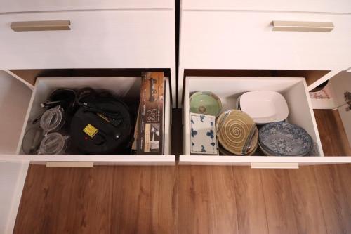 a white cabinet filled with dishes and other items at Dekopin House - Vacation STAY 18550 in Hanamaki