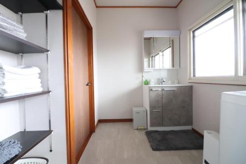 a bathroom with a sink and a mirror at Dekopin House - Vacation STAY 18550 in Hanamaki