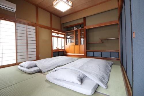 a bedroom with two beds in a room with windows at Dekopin House - Vacation STAY 18550 in Hanamaki