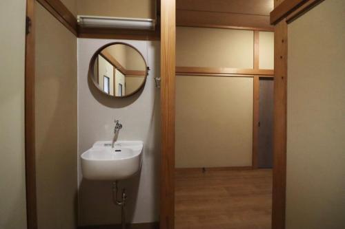 a bathroom with a sink and a mirror on the wall at Dekopin House - Vacation STAY 18550 in Hanamaki