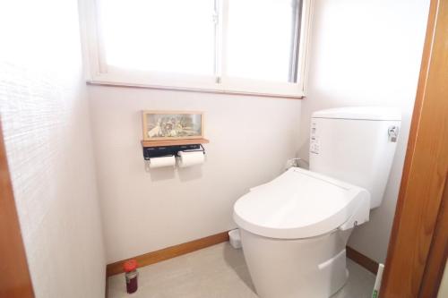 a bathroom with a toilet and a window at Dekopin House - Vacation STAY 18550 in Hanamaki