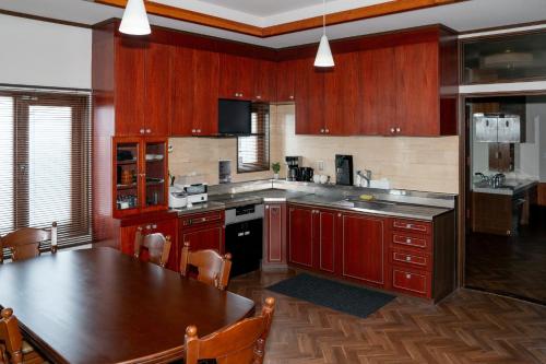 a kitchen with wooden cabinets and a large wooden table at Gold lich - Vacation STAY 18602 in Kamikawa