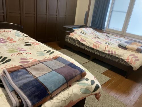 a room with two beds and a blanket at M&Y House - Vacation STAY 31586v in Hakodate