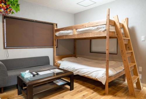 a room with a bunk bed and a couch at Hyuga Surf Camp112 - Vacation STAY 31765v in Hyuga