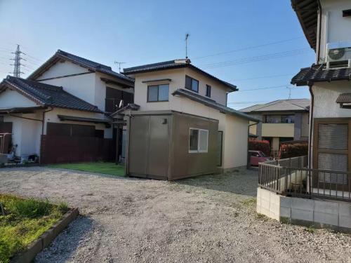 a house with a garage in the driveway at Guest House Wakamizu - Vacation STAY 18625 in Koga